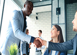 Multiple people and two people shaking hands