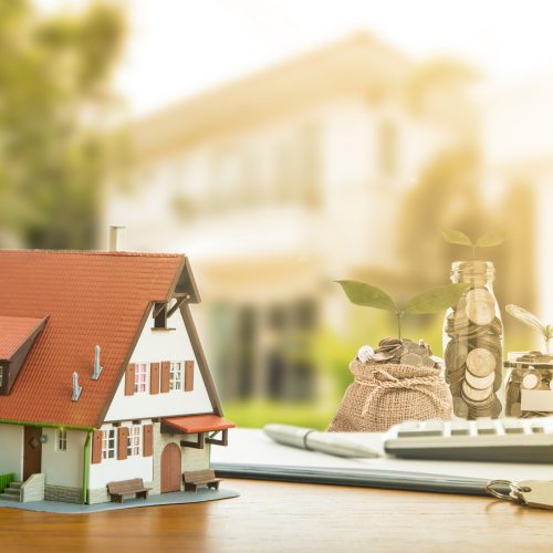 Mortgage and calculator A house with a bag of money